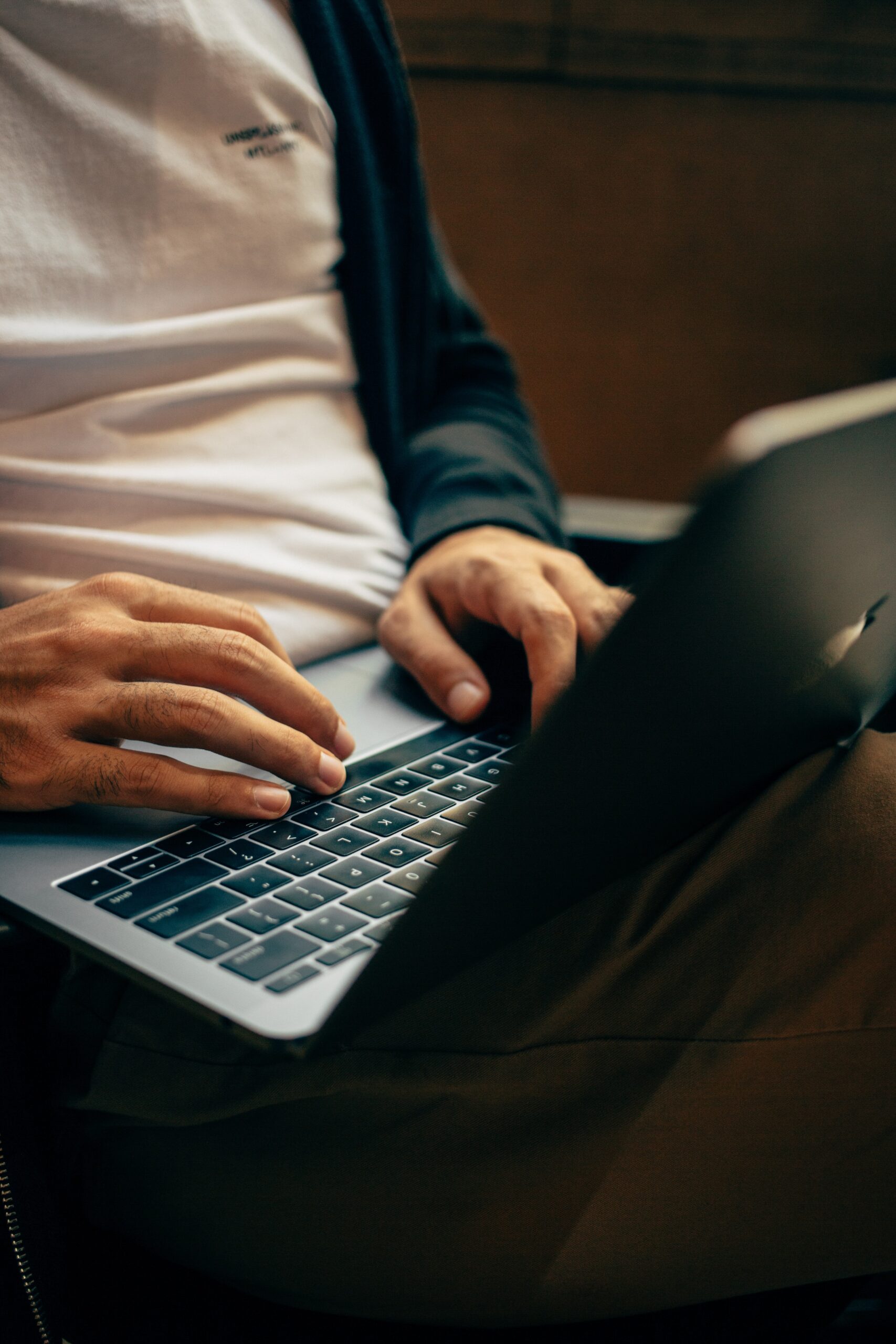 A man typing on a laptop.